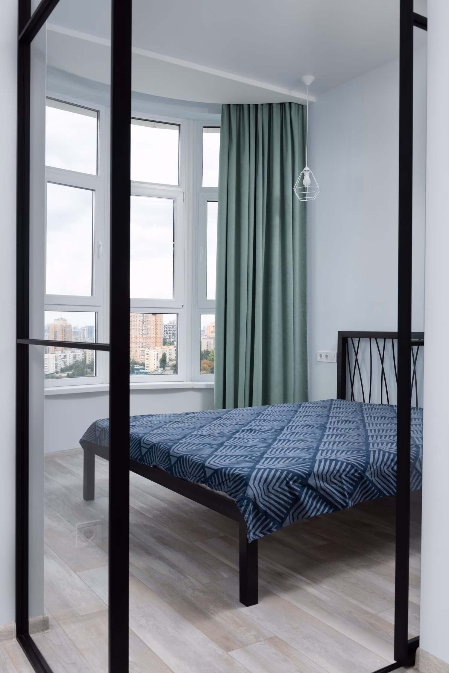 A calm, naturally lit modern bedroom