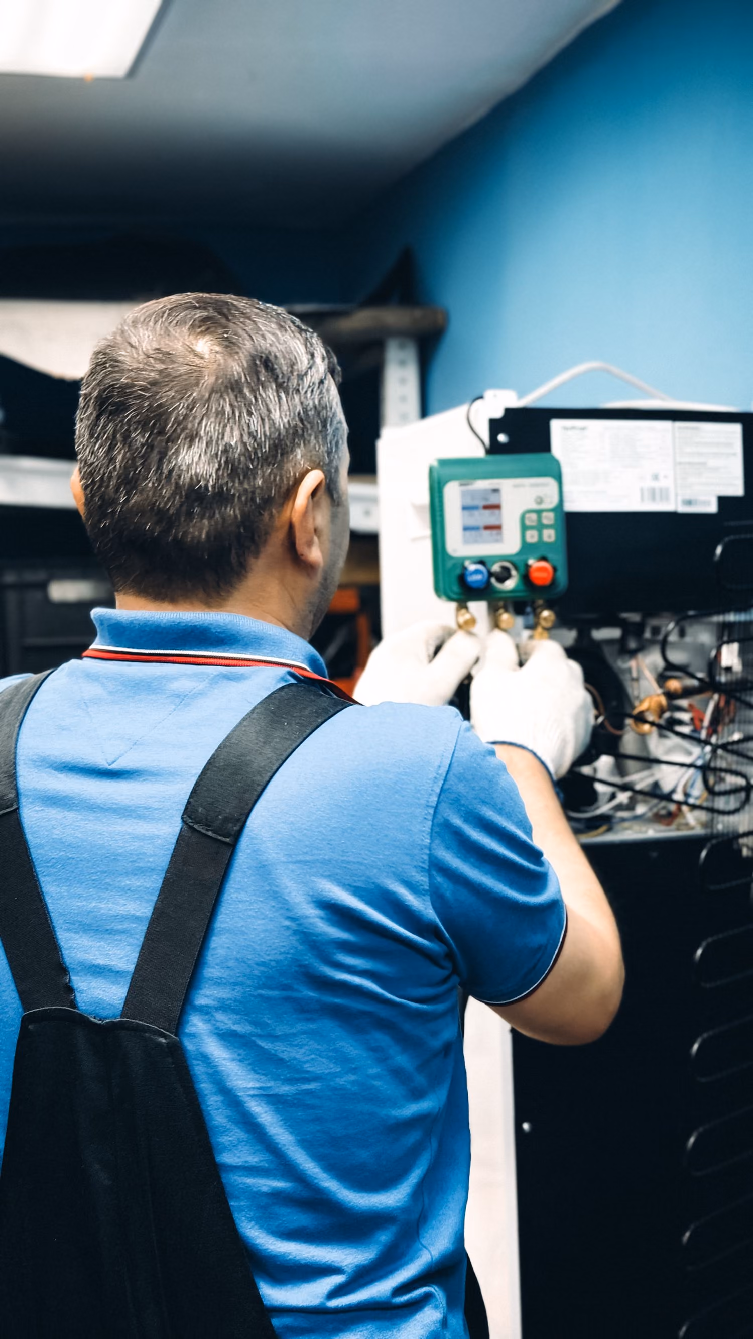 A technician maintaining air-conditioning equipment